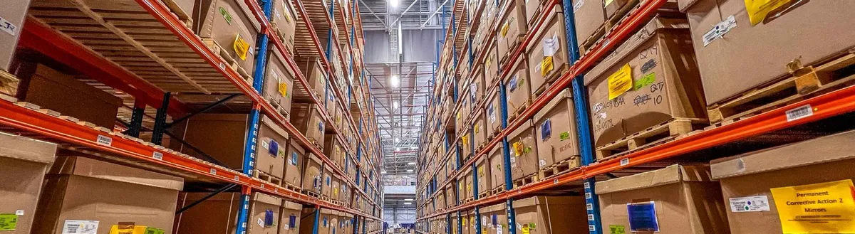 brown cardboard boxes on white metal rack